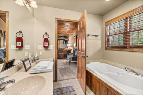 a bathroom with a tub and a sink at Family-Friendly 5BR House by the Lake in Wautoma