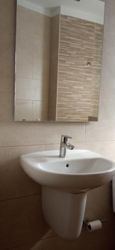 a white sink in a bathroom with a mirror at El Medano . Oceanviews, Amazing Sunset in El Médano
