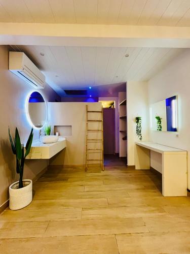 a room with a desk and a sink and a mirror at Villa Côté Sud in Sainte-Luce