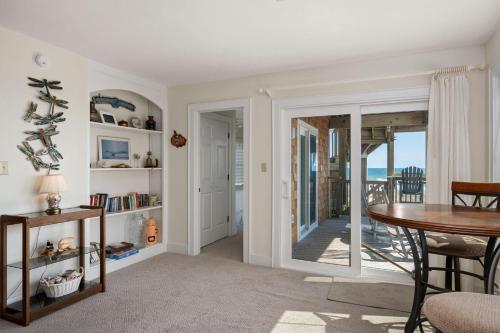 a living room with a table and a view of the ocean at SC04 Sand Castle 4 in Kill Devil Hills