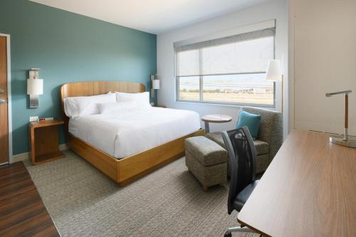 a hotel room with a bed and a chair at Element Austin Round Rock in Round Rock