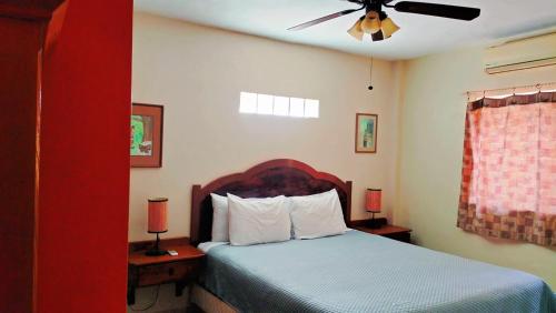 a bedroom with a bed and a ceiling fan at Casa Grande - Coco Cabanas Loreto in Loreto