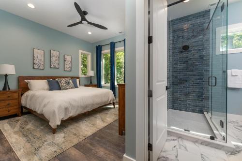 a bedroom with a bed and a glass shower at The Creeks of Serendipity in Black Mountain