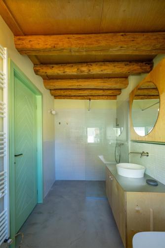 a bathroom with a toilet and a sink and a mirror at Porumbacu 216 in Porumbacu de Sus