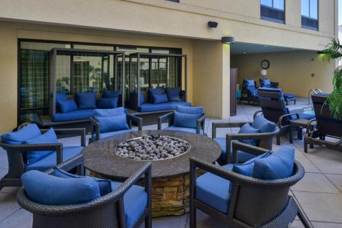 a patio with chairs and a table with a fire pit at Courtyard by Marriott Wilmington Downtown/Historic District in Wilmington