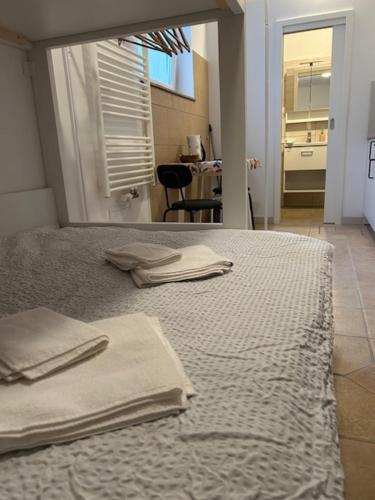 a bedroom with a bed with two towels on it at SOS Apartments in Radovljica