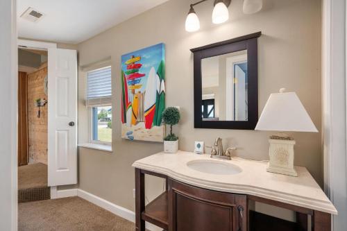 a bathroom with a sink and a mirror at ONHC11D Sunwatch in Nags Head