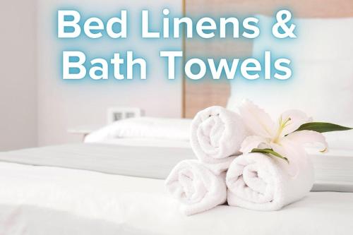 a pair of towels sitting on top of a bed at ONHC101A Blue Water House in Nags Head