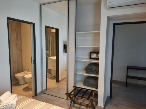 a mirror in a bathroom with a toilet and a sink at In House BA - Le coq in Buenos Aires