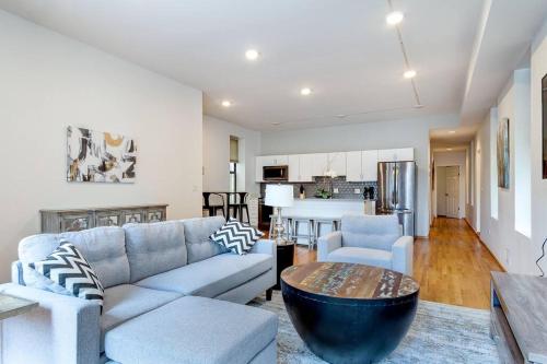 a living room with a couch and a table and a kitchen at Goose Island Central Downtown Prime Location with access to patio CHI - 1 in Chicago