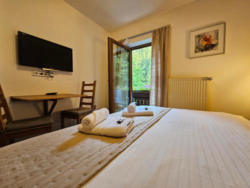 a bedroom with a large bed with towels on it at Ski&Bike Nassfeld Apartments in Hermagor