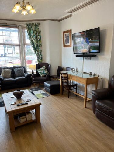 a living room filled with furniture and a flat screen tv at Marston town centre villa in Blackpool