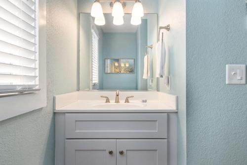 a bathroom with a white sink and a mirror at NH431 Sandy Too in Nags Head