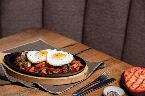a bowl of food with eggs on a table at The Westin Trillium House, Blue Mountain in Blue Mountains