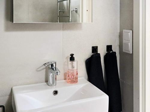 a bathroom with a sink and a mirror at 4 star holiday home in VARBERG in Varberg