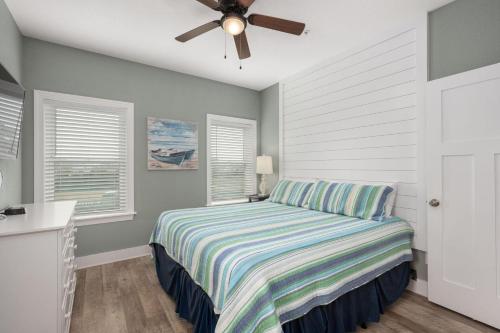 a bedroom with a bed and a ceiling fan at NH387B Ocracoke Cottage in Nags Head