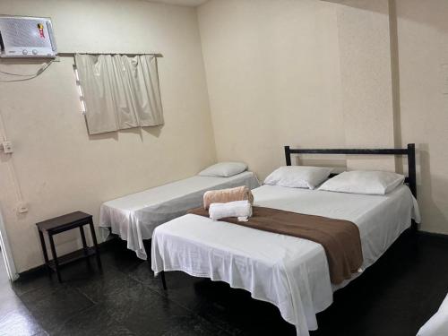 Postel nebo postele na pokoji v ubytování HOTEL DOCE LAR