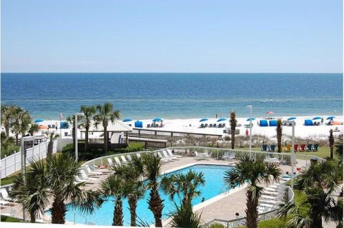 a view of the beach from the balcony of a resort at Seaside Orange Beach, Gulf Front, Tennis, and Pools! in Orange Beach