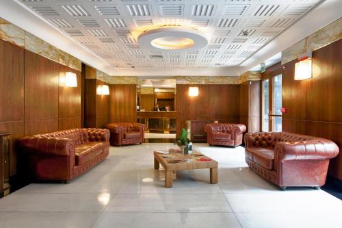 a waiting room with leather couches and a table at Hotel Naples in Naples