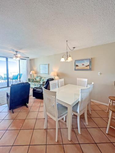 a living room with a white table and chairs at Seaside Orange Beach, Gulf Front, Tennis, and Pools! in Orange Beach
