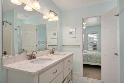 a bathroom with a sink and a large mirror at NH380 Pelican View in Nags Head