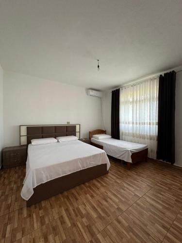 a hotel room with two beds and a window at The Cuni Castle in Shkodër