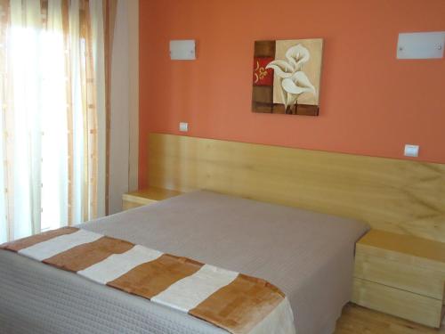 
a bed sitting in a bedroom next to a wall at Hotel Encostas De Nantes in Chaves
