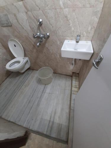 a bathroom with a toilet and a sink at Couple Friendly Rooms in kolkata