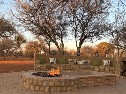 a fire pit in the middle of a park at Camel Creek Safari Lodge in Thabazimbi