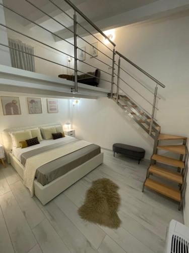 a bedroom with a large bed and a staircase at Rachele Boutique Apartments in Agropoli