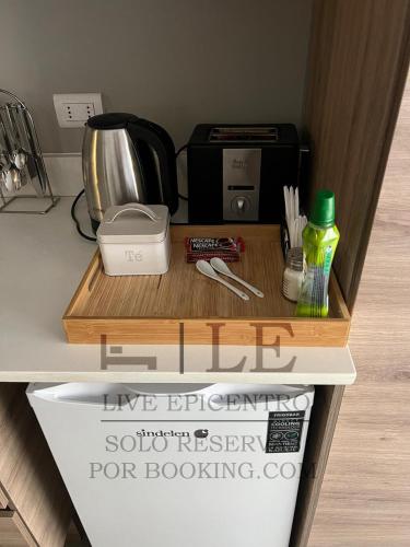 a kitchen counter with a cutting board and a coffee maker at Live Epicentro in Temuco