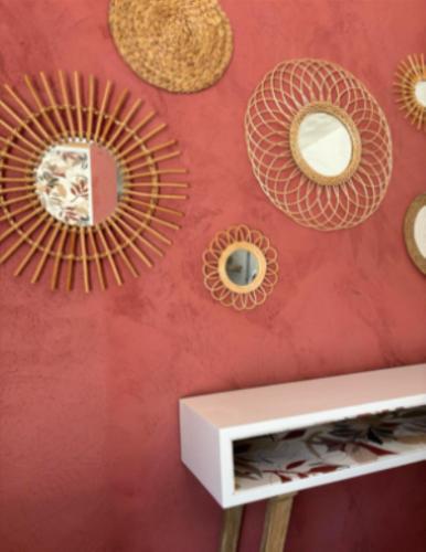 a wall with mirrors on a red wall at Les Gîtes W''elles''come in Cotignac