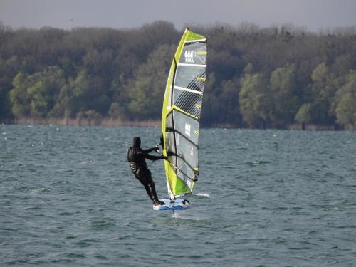 a man is windsurfing in the water at Les chalets Aux Gîtes d'Orient in Géraudot