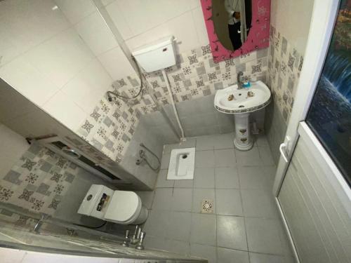 a small bathroom with a sink and a toilet at فندق عسل - Asal Hotel in Baghdad