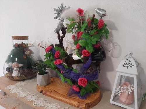 a table with a vase with flowers on it at Apartmani Show Zagreb in Zagreb