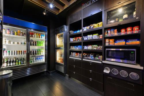 a kitchen with a refrigerator and lots of food at Courtyard by Marriott Wilmington Downtown/Historic District in Wilmington