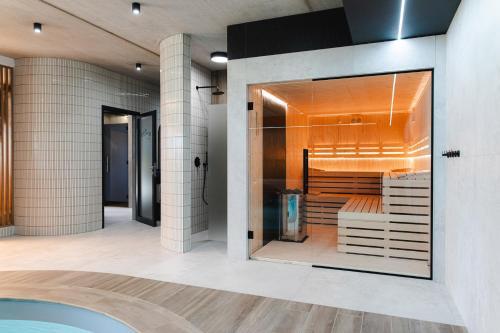 a bathroom with a shower and a tub at Apartamenty Złote Tarasy in Brodnica Dolna