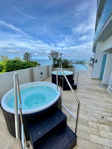 a jacuzzi tub on the balcony of a house at APARTAMENTO VISTA AL MAR WIND 906 in Gaira