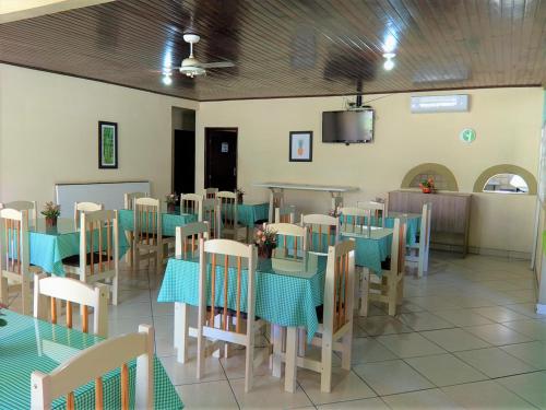 a dining room with blue tables and chairs at Hotel Vale Das Serras in Jacobina