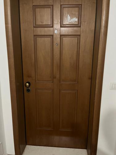 a wooden door in a room with a floor at Resa Apartment in Vlorë