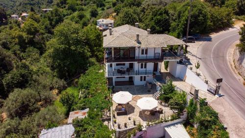 an aerial view of a house with umbrellas at Paradeisos Rooms Pelion in Agios Dimitrios