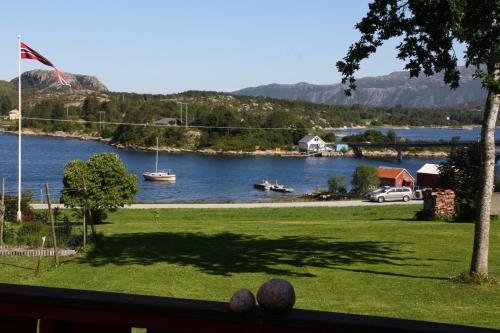 a view of a river with a boat in the water at Åkviktunet hytte nord in Averoy