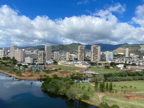 an aerial view of a city with a river and buildings at Amazing View Waikiki Beach 28th Floor 1BR Family and Group Condo in Honolulu