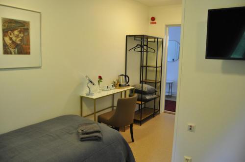 a bedroom with a bed and a desk with a computer at långstorp in Höör