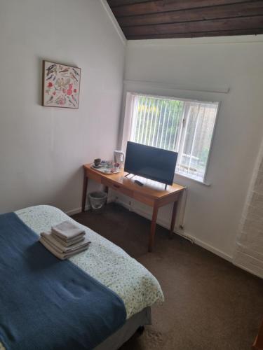a bedroom with a desk with a computer on it at The Bulls Head - Clipston in Clipston