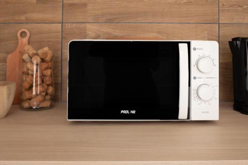 a microwave sitting on top of a table at Jungle appartement lumineux plein centre in Boulogne-sur-Mer