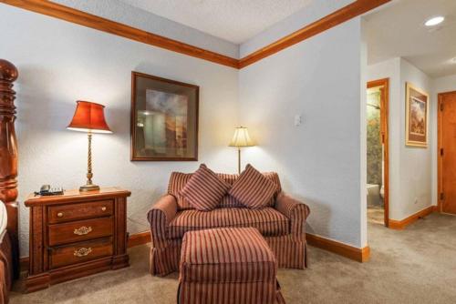 a living room with a couch and a lamp at The Charter at Beaver Creek F215 in Beaver Creek