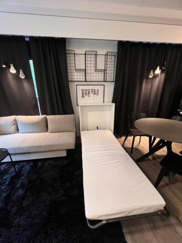 a living room with two beds and a table at Loviisan Helmi 102 in Lovisa