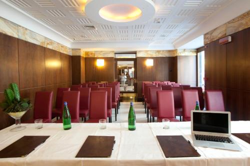 a conference room with a table with a laptop on it at Hotel Naples in Naples