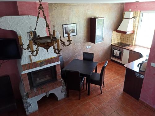 a living room with a table and a fireplace at Apartaments Gory in Niedzica Zamek
